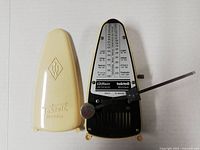 Metronome with cover removed showing dial and pendulum