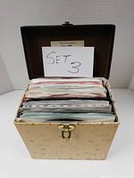 Carry case open displaying sleeves and set number