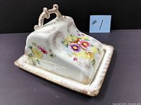 Oblique view of assembled cheese dish showing floral design and gilt edges