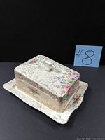 Covered cheese dish three-quarter view showing floral pattern and undertray