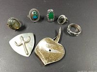 Front view showing five sterling rings and two brooches