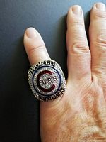 Ring on hand showing scale and face details