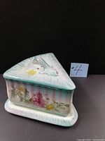 Front angled view showing floral decoration and triangular form