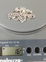 Chain on scale reading 16 grams