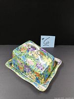 Cheese dish three-quarter view showing floral chintz pattern and handle