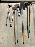 All gardening tools laid out on floor