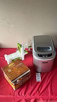 Full view of all three items: RCA ice maker, Starfrit mandoline slicer, boxed Marcato pasta maker
