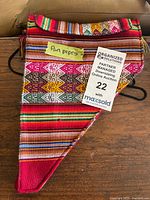 Woven cloth bag front view with note and auction tag