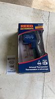 Front of sealed Reed Instruments R2310 infrared thermometer package