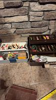 Two tackle boxes open showing contents