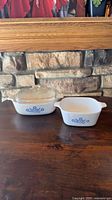 Two square CorningWare casseroles side by side, one with glass lid