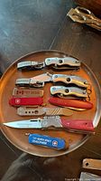 Overview of all thirteen pocket cutters and multi-tools on plate