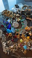 Overview of mixed costume jewelry spread on table