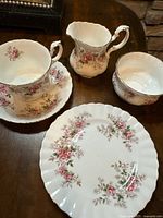 Full set view: teacup on saucer, creamer, sugar bowl, dessert plate