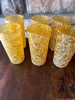 Six amber textured highball glasses on table