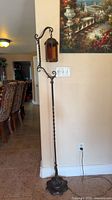 Full view of floor lamp showing height, pole, base, cord
