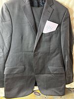 Front view of charcoal gray suit jacket with trousers