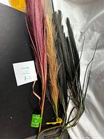 Group of mixed colour artificial grass stems with tags visible