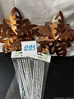 Two metal snowflakes and two unopened packs of silver icicles