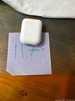 Closed white charging case on surface