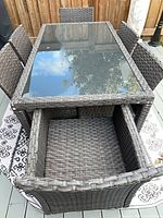 Entire wicker patio dining set showing table and six chairs