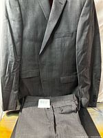 Full view of jacket and trousers displayed together
