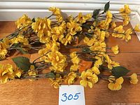 All three yellow floral stems laid flat showing overall condition and tags