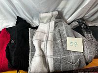 Group of four knit scarves showing colors and patterns