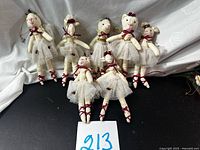 Front view of eight fabric rabbit ballerina ornaments standing upright