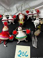 Group shot of nine whimsical mixed-media Christmas ornaments