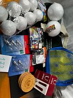 lot overview with craft balls, bulbs, Merlin kit, gems, Umbra packs, coasters, tote, pouch
