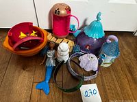 Overall view of mixed toy items on floor