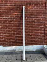 Full length view of retractable screen against brick wall