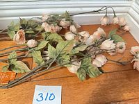 Garland laid out showing multiple stems with pink blossoms and green leaves