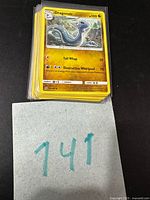 Stack of sleeved Pokémon cards, Dragonair on top
