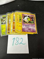 Stack of sleeved Pokémon cards with Natu visible on top