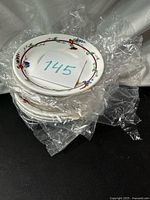 Stack of saucers still in protective plastic