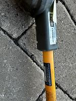 Close-up of Ryobi label on shaft