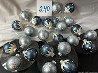 All 24 glass ornaments on trays showing designs and colors