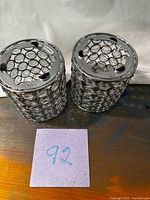 Top view of two chrome crystal trim cylinders