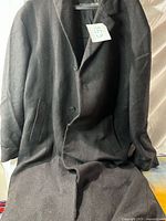 Front view of charcoal herringbone overcoat on hanger