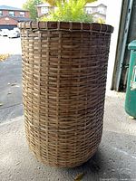 full view of cylindrical woven wicker planter