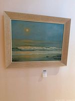 Full view of framed painting on wall showing moonlit seascape