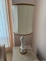 Full view of lamp with shade on side table