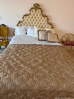 Front view of assembled bed with tufted headboard, bedding visible