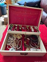 Open Birks jewelry box showing all jewelry pieces in tray and bottom compartment