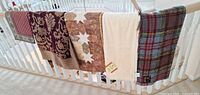 All five blankets/throws hanging on railing