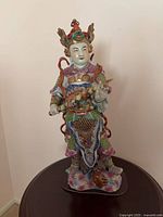 Full view of porcelain Wei Tuo figurine on base