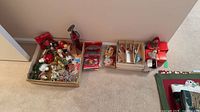 Overall view of boxed assortment of Christmas ornaments and two lantern-style decorations