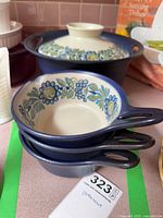 Casserole with lid and three bowls showing pattern and colour